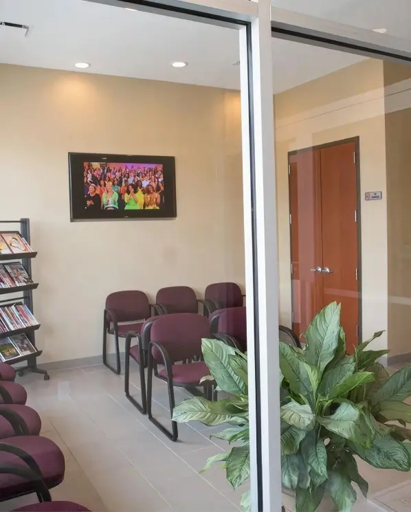 PM Dental Care welcoming reception area with comfortable seating and green plants.
