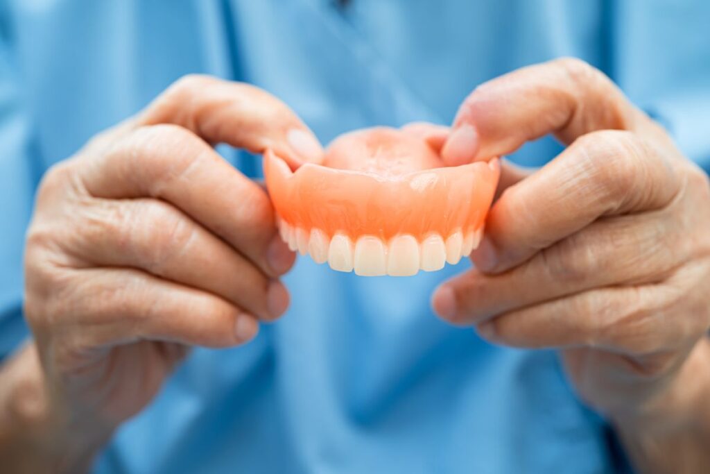 Removable dentures held by a dental professional